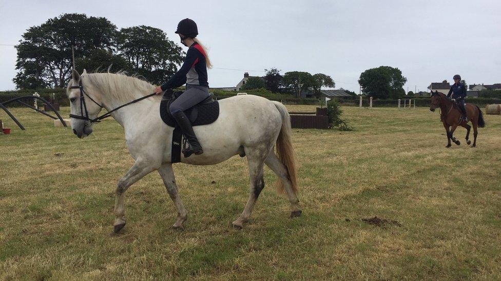 A girl riding a horse