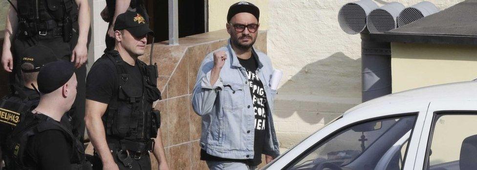 Russian theatre director Kirill Serebrennikov (3rd R), who was accused of embezzling state funds, is escorted outside a court building after a hearing on his detention in Moscow