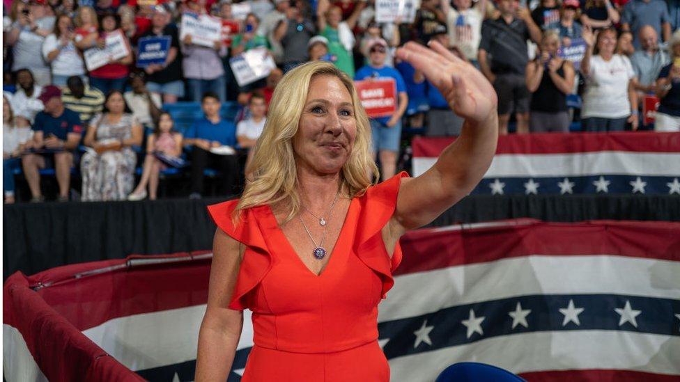 Marjorie Taylor Greene waves to supporters at a Donald Trump rally.