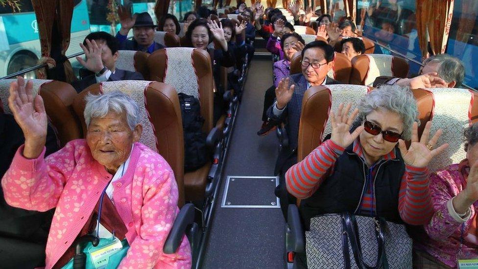 South Koreans with family members or relatives who remain in North Korea, separated by the 1950-53 Korean War, wave aboard a bus in the city of Sokcho, on South Korea"s east coast, 20 October 2015, before they cross the inter-Korean border to reach a resort on Mount Kumgang on the North's east coast to have reunions with their loved ones in the North.