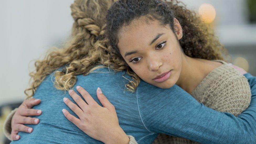 teenage girls hugging