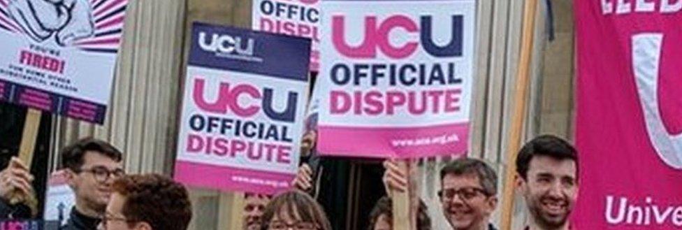 People striking outside a university