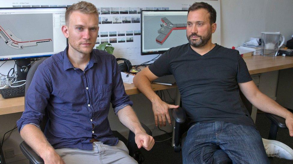 Forensic Architecture's Stefan Laxness (left) and Eyal Weizman in front of screens showing Syria's Saidnaya military prison