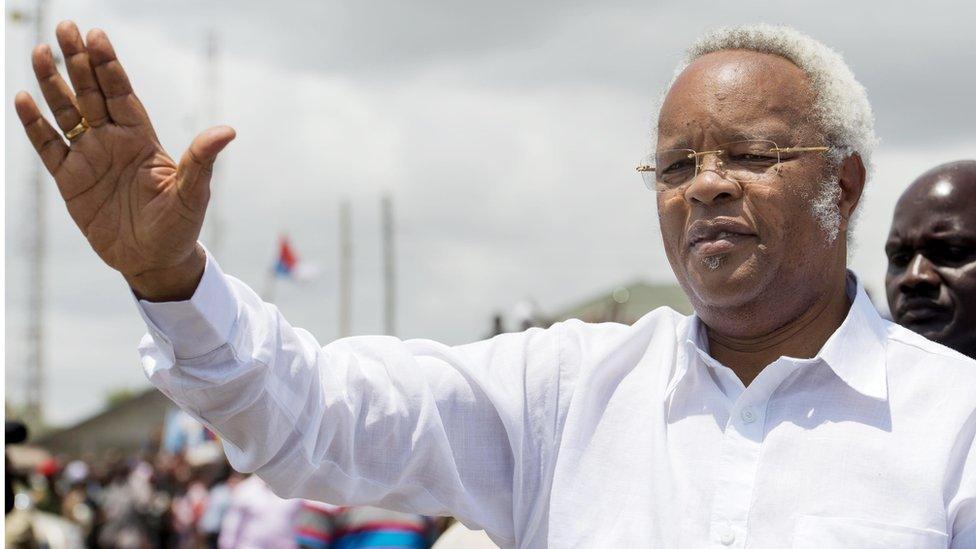 Former Prime minister and presidential candidate Edward Lowassa greets the crowd as he arrives to hold a campaign meeting in Dar es Salaam