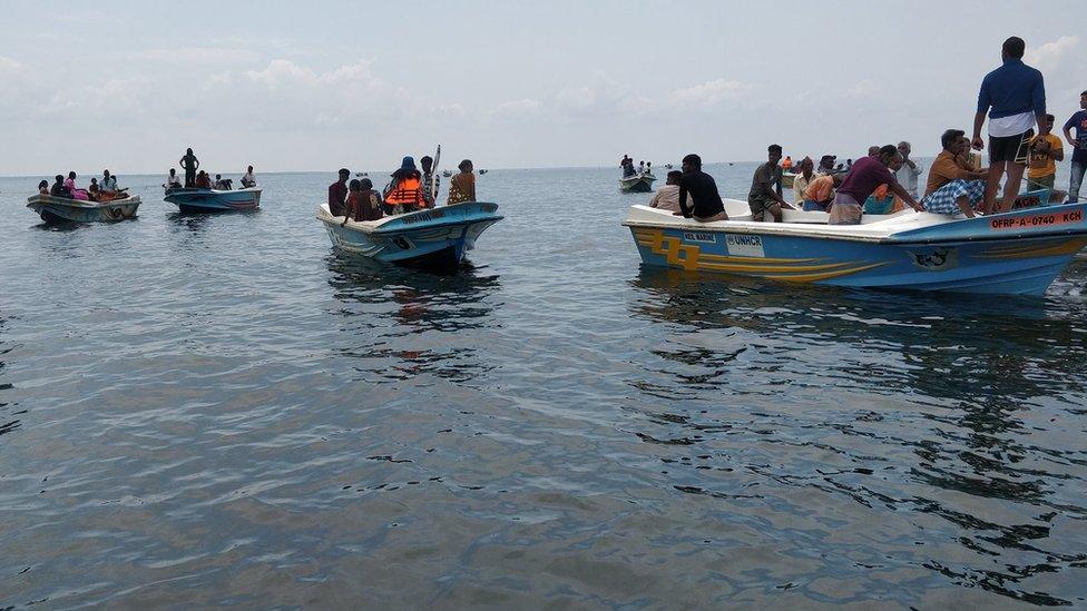 Flotilla of boats sailing to the island