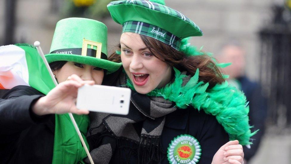 Two women take a selfie during the St Patrick's Day Parade in Dublin, Ireland, 17 March 2017