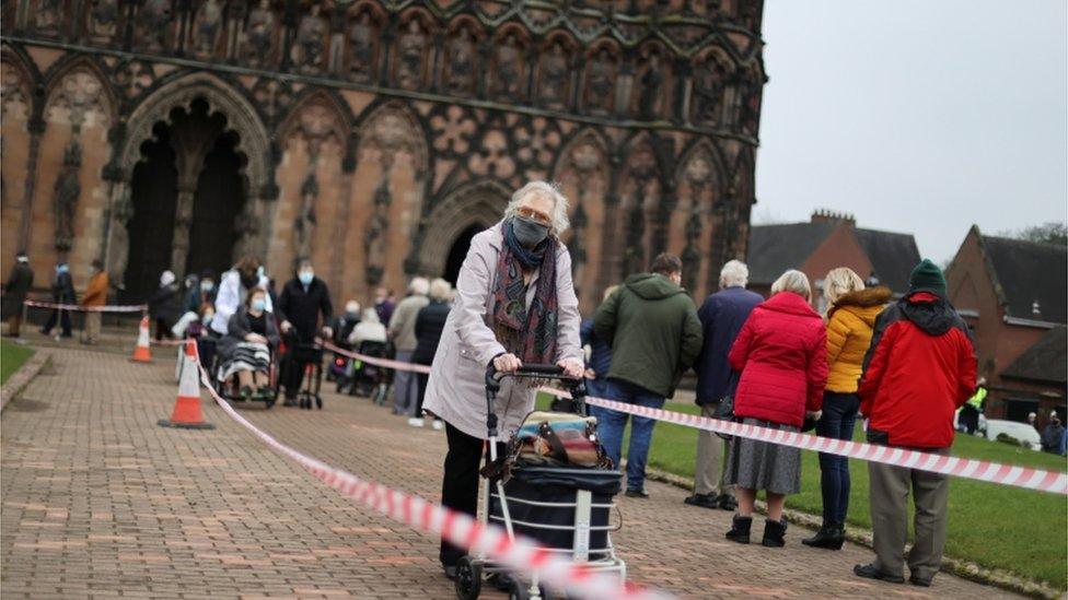 People queue to receive their COVID 19 vaccines inside Lichfield Cathedral