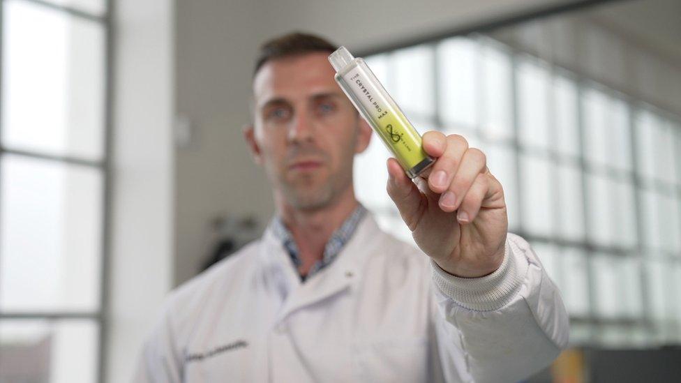 Scientist holding a vape