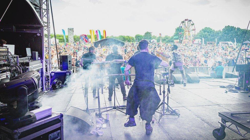 A band performing on a festival stage