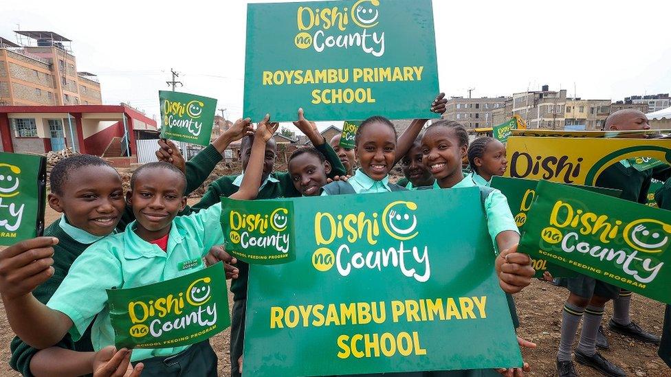 children-holding-signs-for-new-meal-programme.
