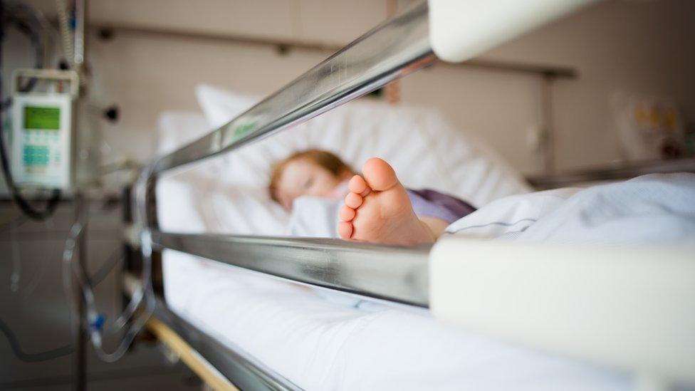 Young girl lying in a hospital bed