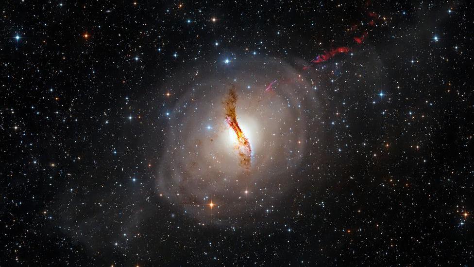 This picture shows the galaxy NGC 5128 and its surrounding tidal wave system as well as a visualization of the relativistic jet, powerful jets of radiation and particles travelling close to the speed of light.