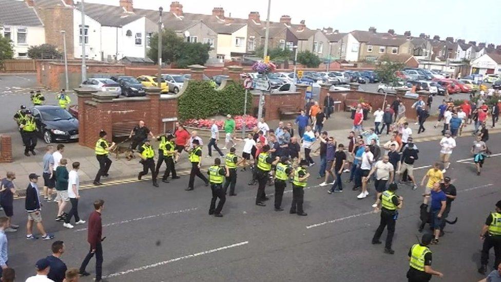 Stand off between police and football fans