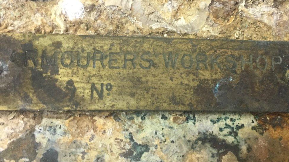 Armourers Workshop stamped on metal plate