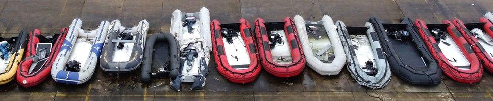 Row of small boats used by migrants in Dover