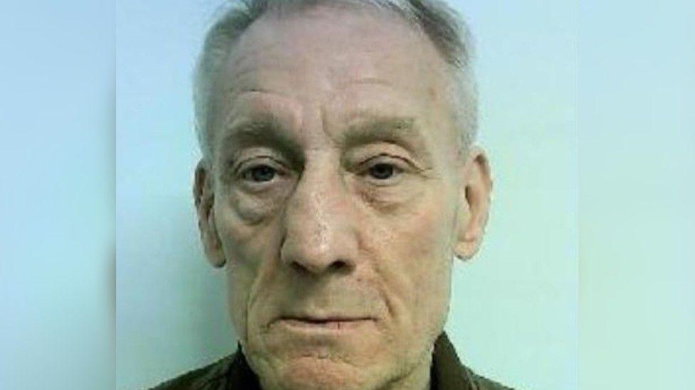 Mugshot of Stephen Grimes looking into the camera with short grey hair