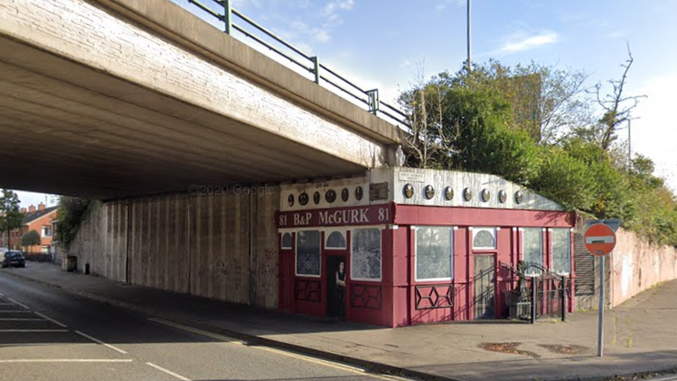 A memorial is painted on the motorway flyover where McGurk's bar used to stand