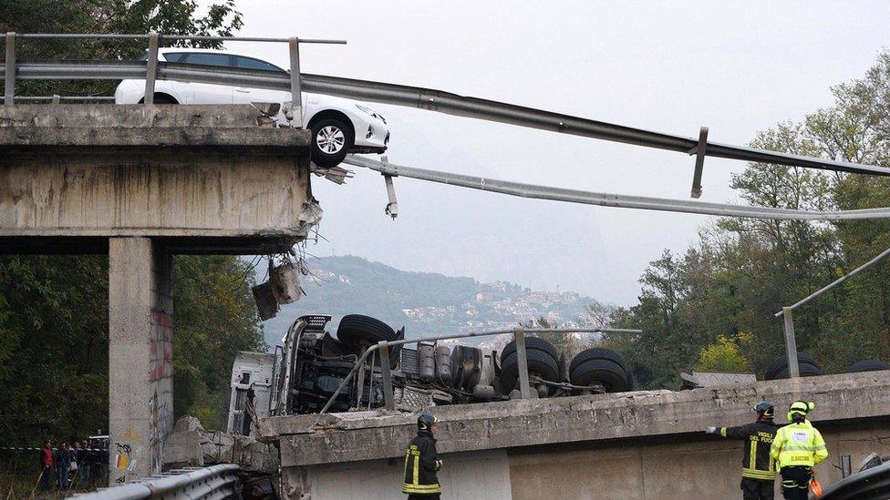 A car suspended at the collapsed bridge between Milan and Lecco, northern Italy, 28 October 2016.