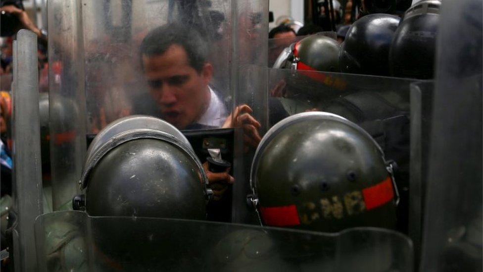 Mr Guaidó pushes against a riot shield on 7 January 2020