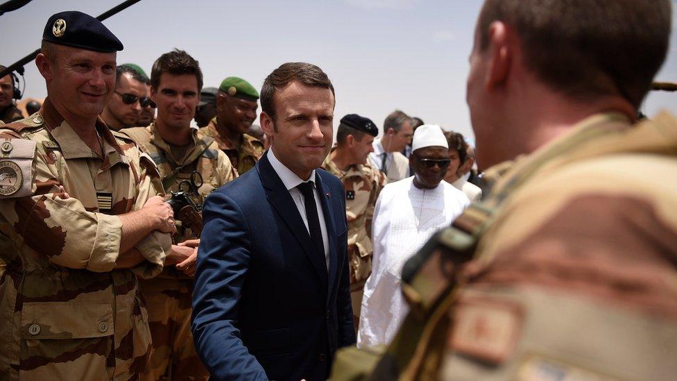 French President Emmanuel Macron shakes hands with a French soldier during a visit to Mali