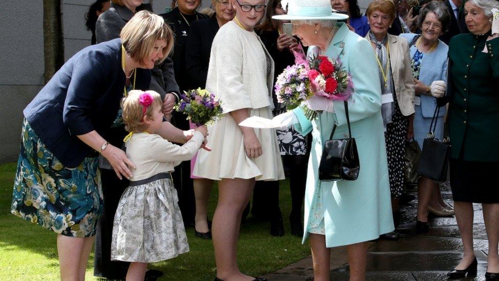 queen receiving flowers