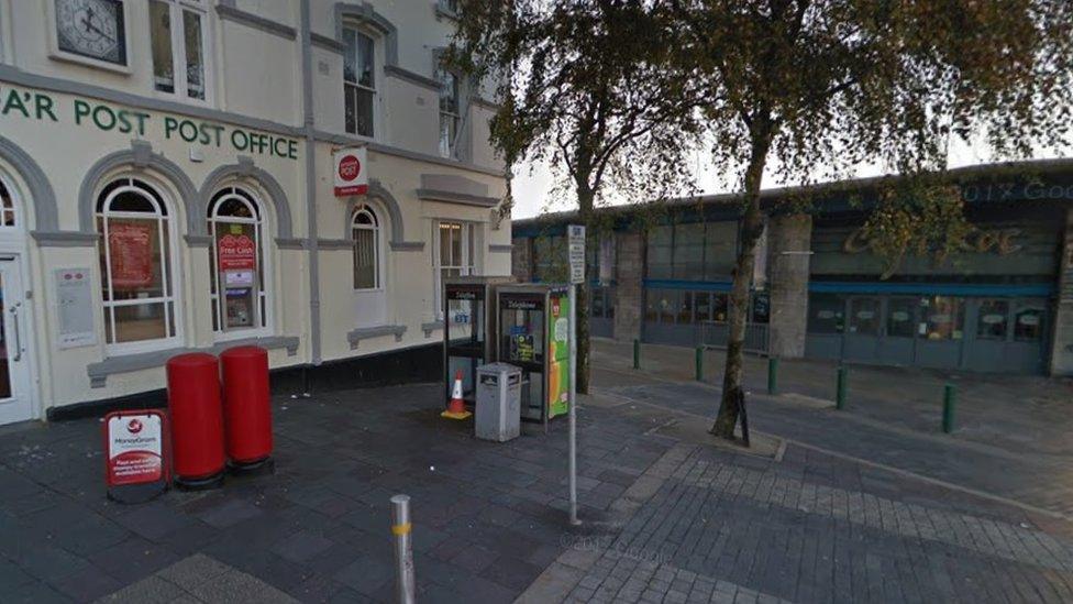 Phone boxes are outside the town's main post office