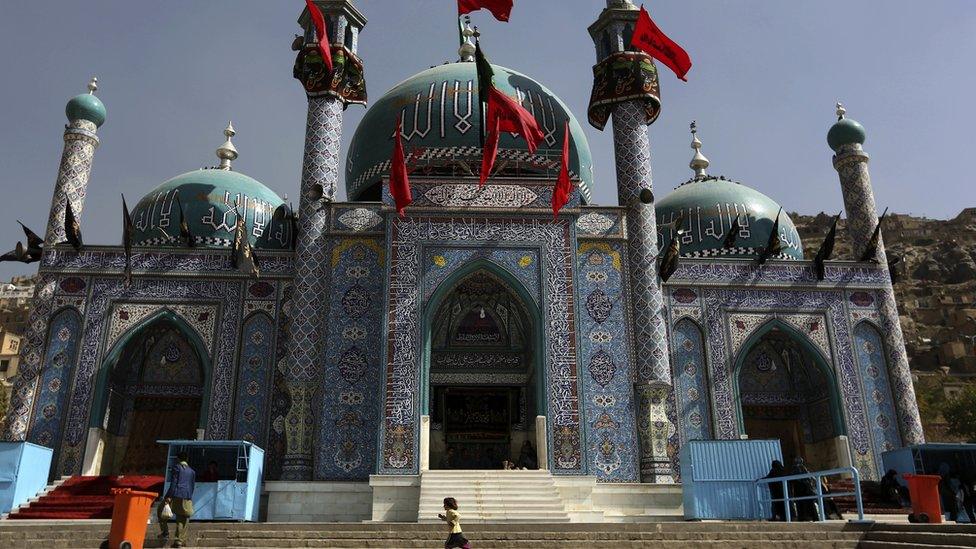 In this Sunday, Oct. 9, 2016. photo, an Afghan Shia girl runs in front of the Karti Sakhi shrine during a commemoration of Ashura in Kabul, Afghanistan,