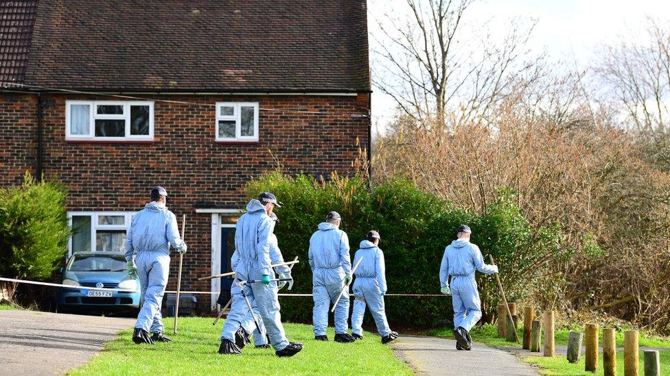 Police officers search the scene at Harold Hill