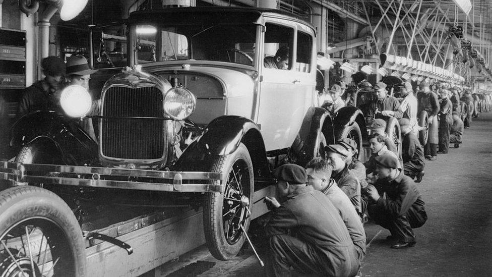 Assembly line workers inside the Ford Motor Company factory at Dearborn, Michigan, in 1928