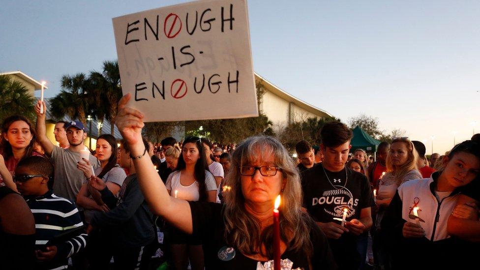 Mourners stand during a candlelight vigil for the victims of Marjory Stoneman Douglas High School shooting in Parkland, Florida on February 15, 2018.