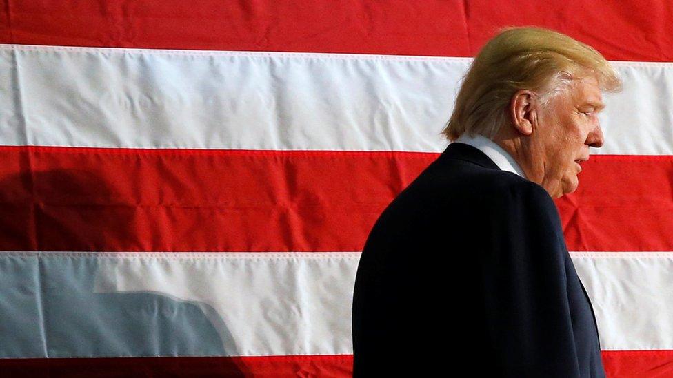 Donald Trump (walks in front of Stars and Stripes flag of the United States) during campaign rally in Colorado