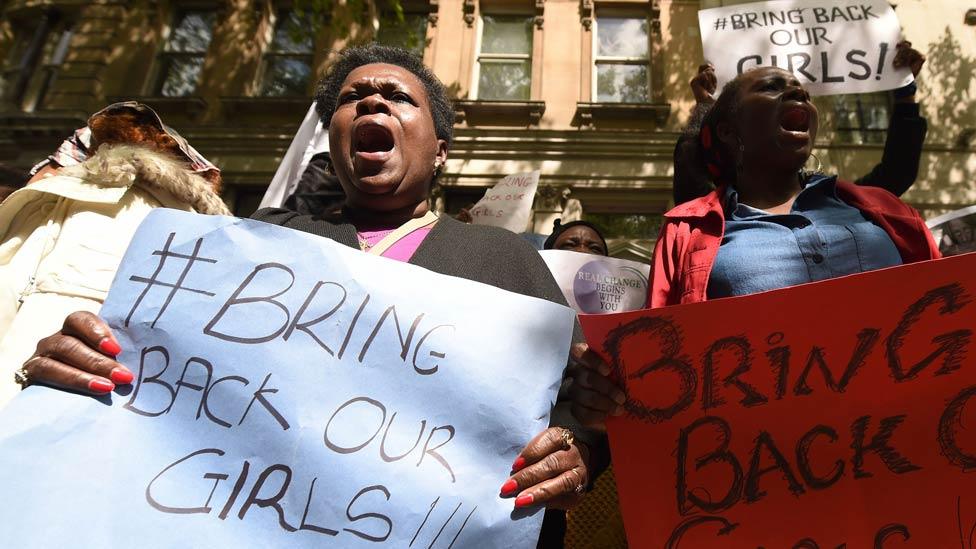 Protestors hold placards as they demonstrate outside Nigeria House in central London on May 9, 2014