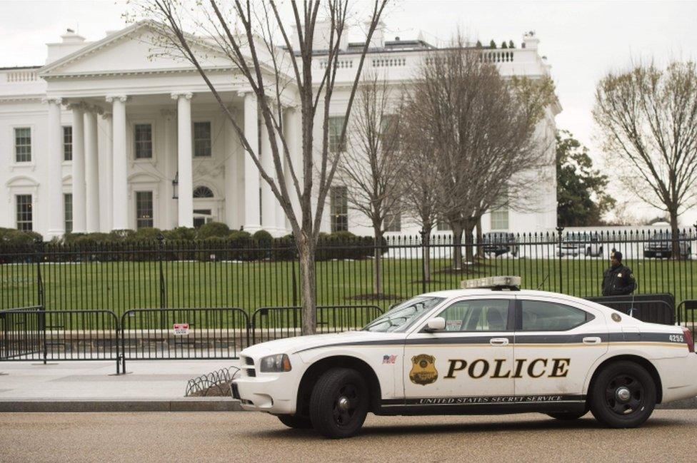 Members of the Secret Service Uniformed Division patrol alongside the security fence around the perimeter of the White House in Washington, DC, on March 18, 2017.