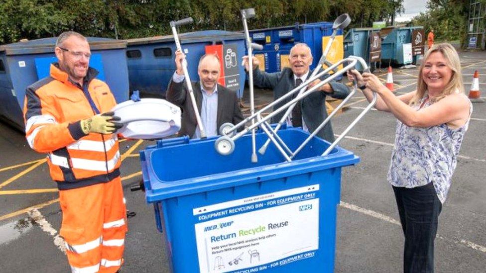 People putting crutches in a bin