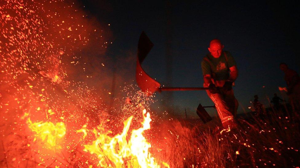 A firefighter tackles the Winter Hill blaze in June 2018