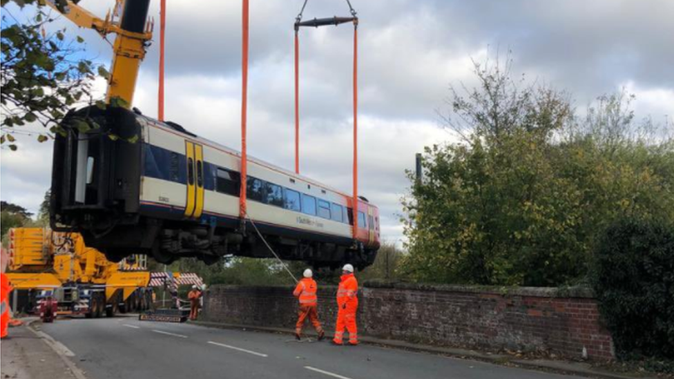 Train carriage lifted by crane