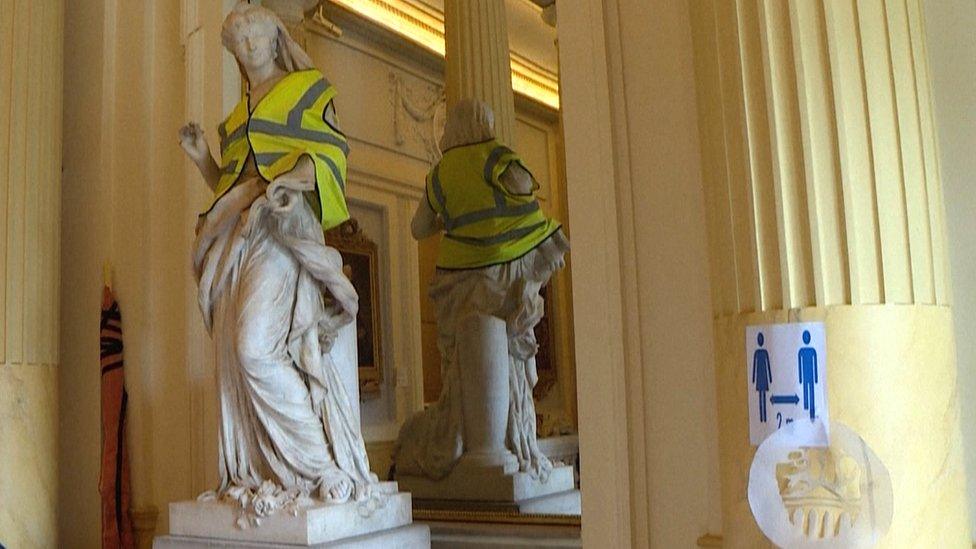 This statue in the Odeon Theatre in Paris has been draped with a yellow vest synonymous with earlier anti-Macron protests