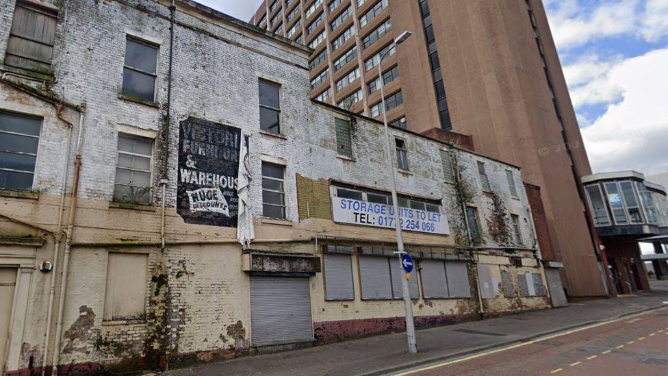 Street view of derelict buildings on the proposed Church Row apartments site