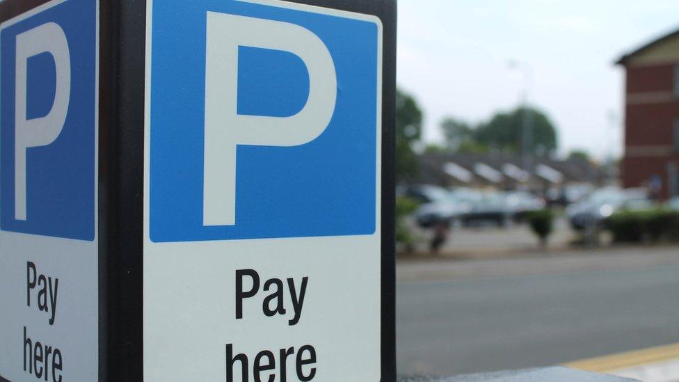 Parking machine with sign