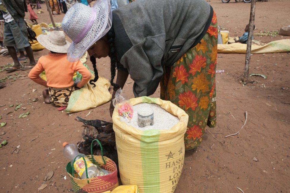 This picture taken in March 2015 shows a street vendor selling rice imported from Pakistan, as a result of the scarcity of non-imported food due to prolonged drought, in the village of Ambonaivo, in the Tsihombe district of southern Madagascar