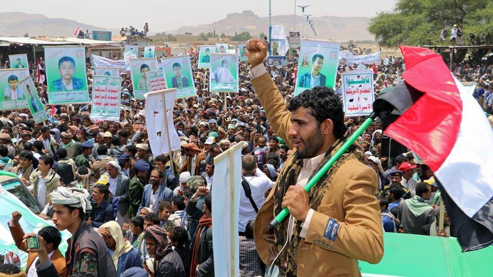 Mourners hold signs and slogans at the funerals on 13 August 2018 of children killed in a Saudi-led coalition air strike