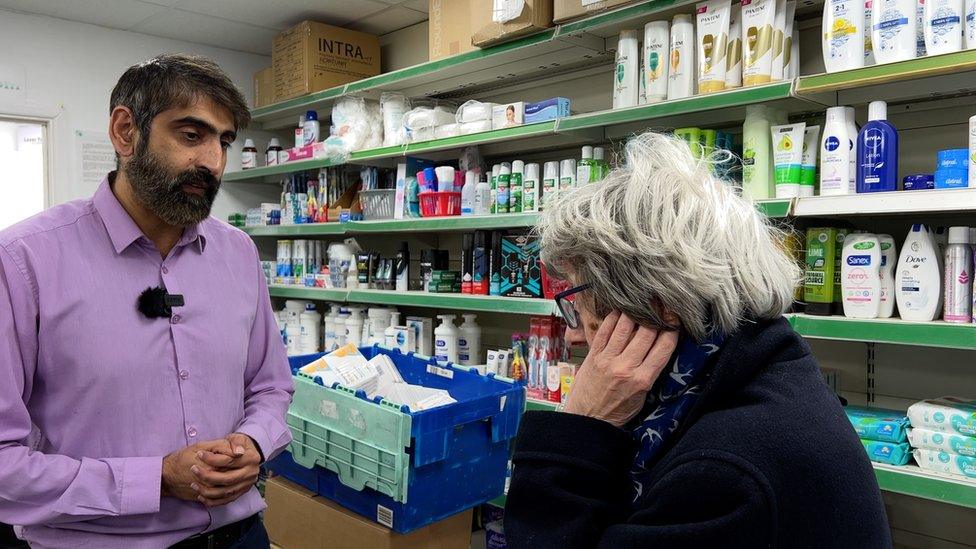 Yarnton pharmacists Raza Hassani speaks to a customer