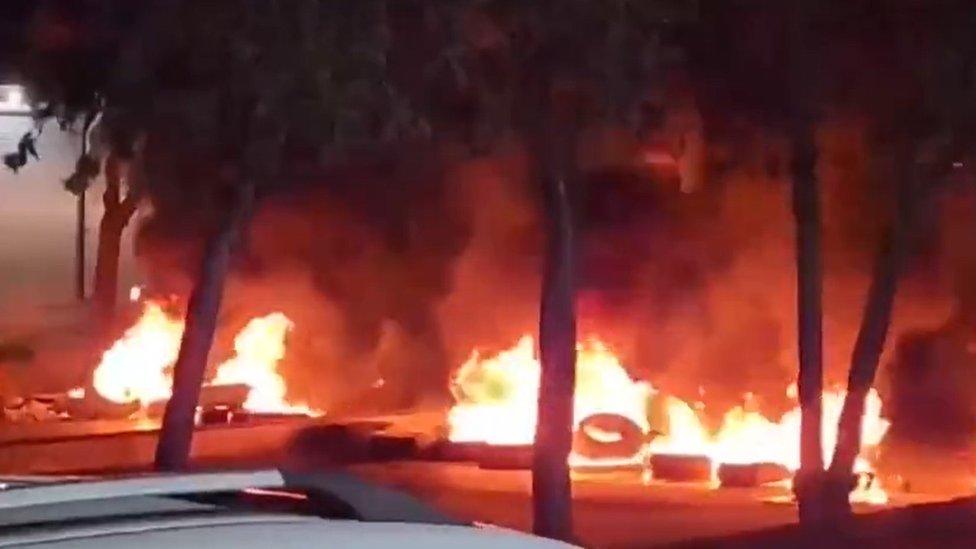 Footage posted by Kurdish rights group Hengaw purportedly showing burning tyres blocking a road in Sanandaj during an anti-government protest (16 February 2023)