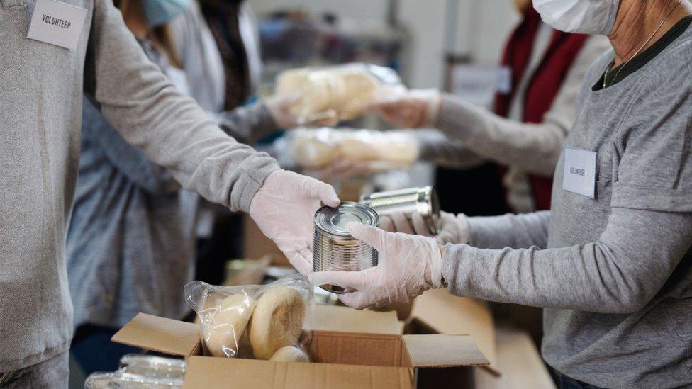 Food bank volunteers pack boxes