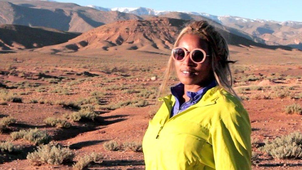 Hafida standing in front of mountains