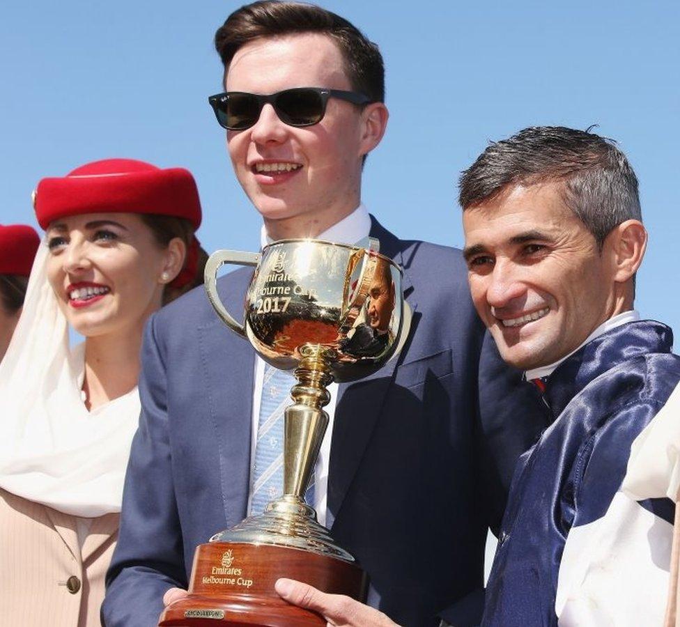 Jockey Corey Brown poses with the Melbourne Cup next to winning trainer Joseph O"Brien after winning on Rekindling to win race 7 the Emirates Melbourne Cup during Melbourne Cup Day at Flemington Racecourse on November 7, 2017 in Melbourne, Australia.