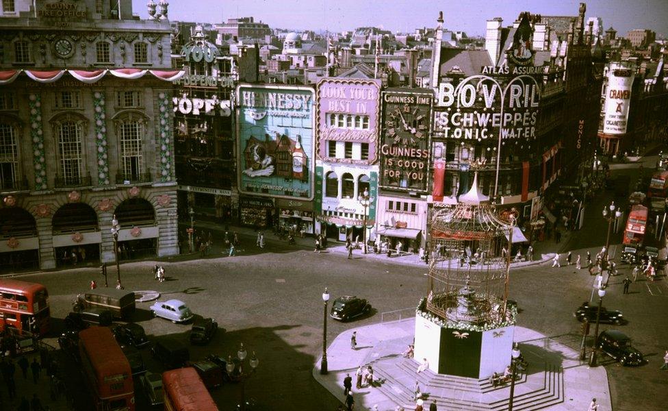 Piccadilly Circus lights in 1953 with decorations for the Coronation