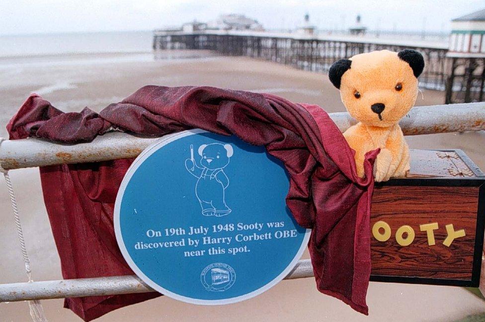 Sooty in 1997 at Blackpool North Pier with a plaque marking his purchase by Harry Corbett