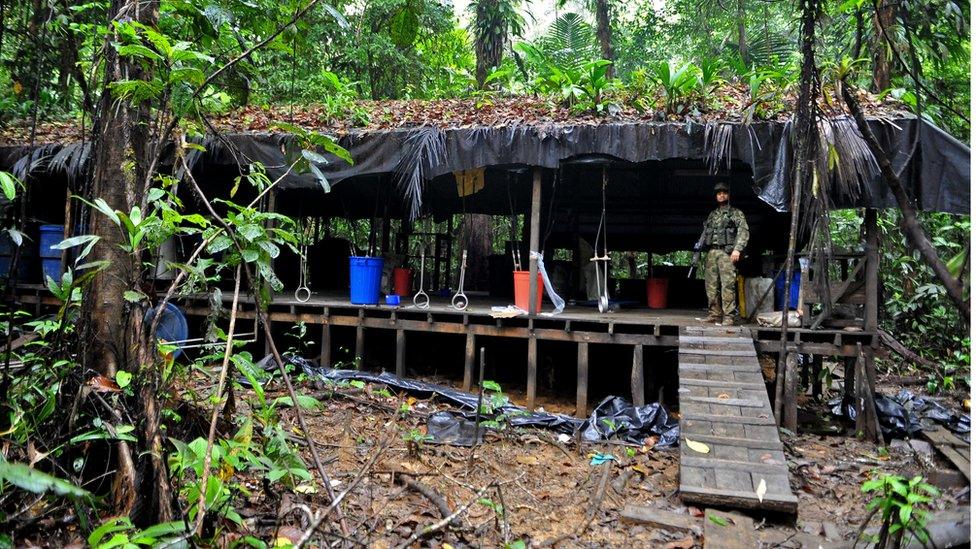 A Colombian soldier stands guard inside a cocaine laboratory in the forest area of Buenaventura, Valle del Cauca department, Colombia, on March 17 2010.