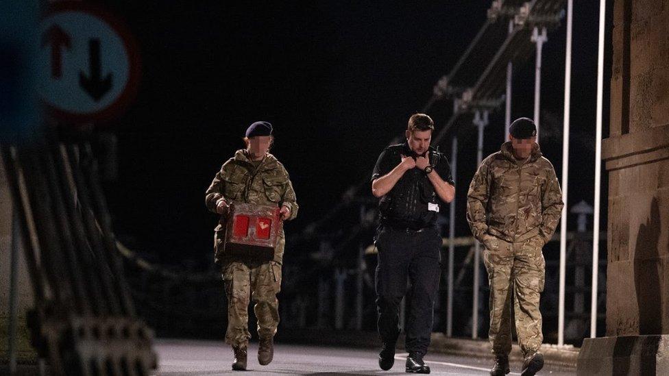 Bomb disposal team retrieving grenade